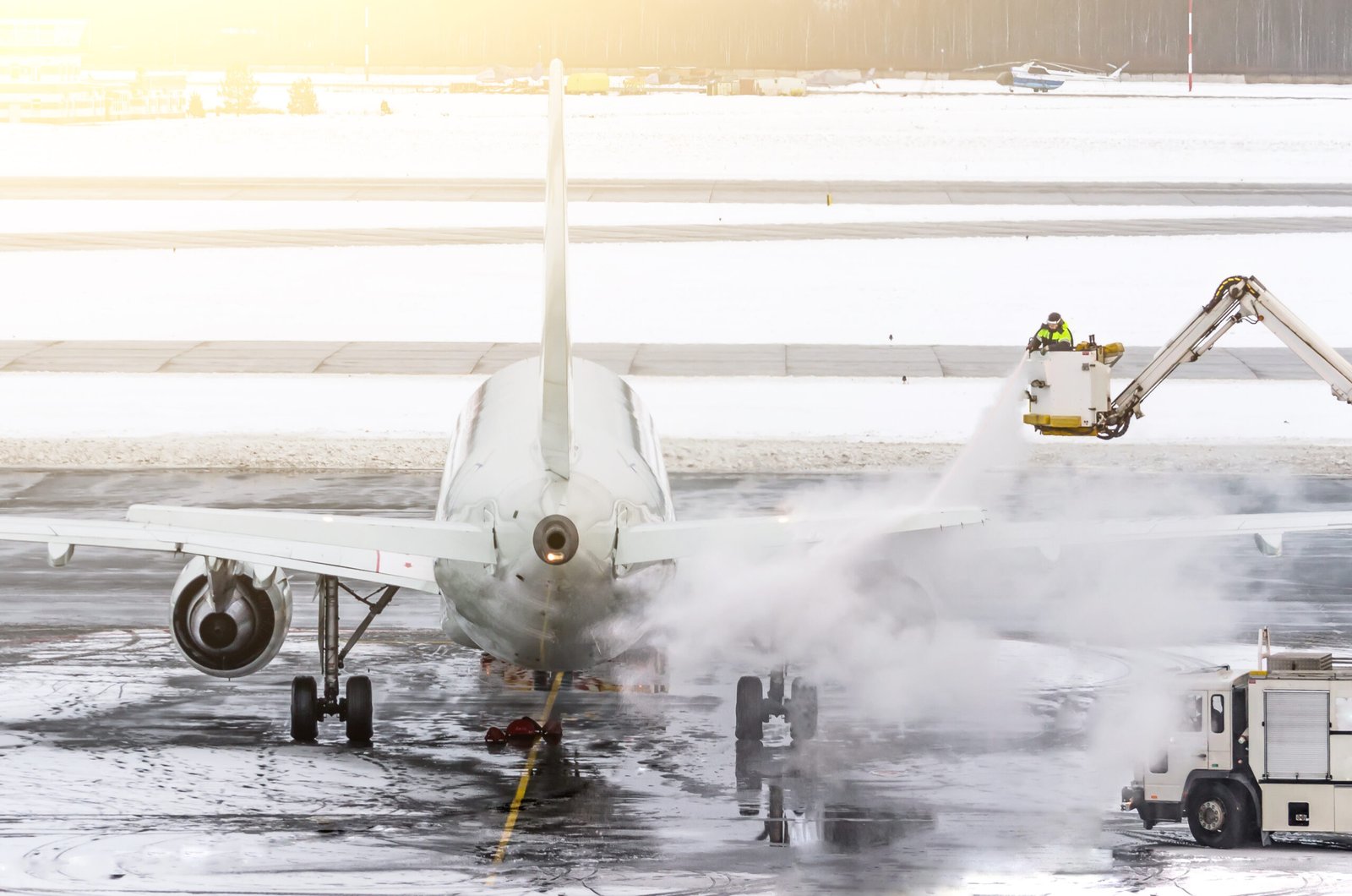 Ground crew provides de-icing. They are spraying the aircraft, which prevents the occurrence of frost.